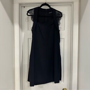 Little black dress with lace cut outs and lace embellishments by Kooplss size M